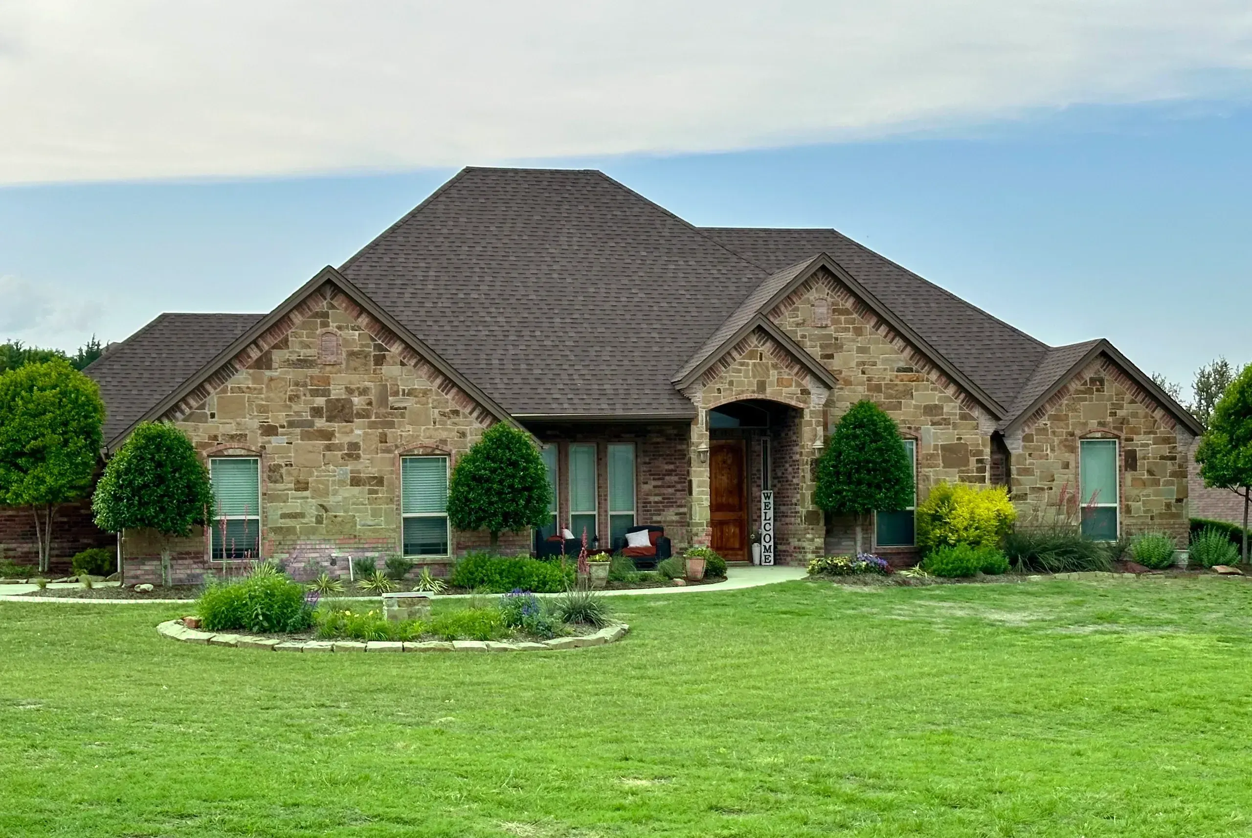 Brick-and-stone Texas home with a new architectural shingle roof